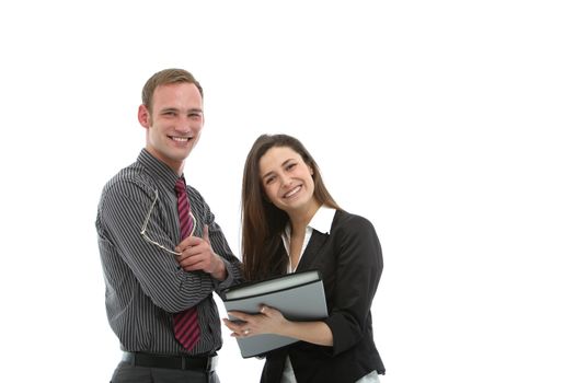 Two smiling confident young businesspeople standing together sharing information in a successful business partnership