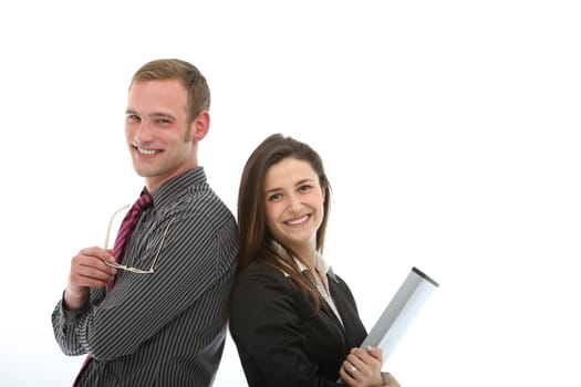 Smiling confident businessman and businesswoman standing back to back in a teamwork and partnership concept