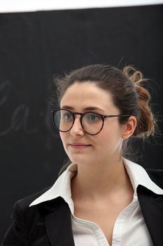 Portrait of woman with glasses on black background