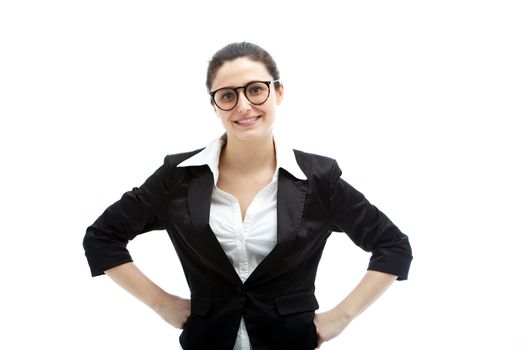 Confident smiling businesswoman in glasses standing with her hands on her hips exuding an air of authority