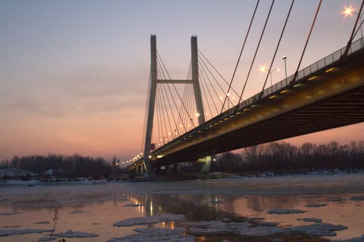 Road bridge in Warsaw, the time of evening, seen from the Vistula River