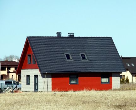 The red house on a background of the sky 