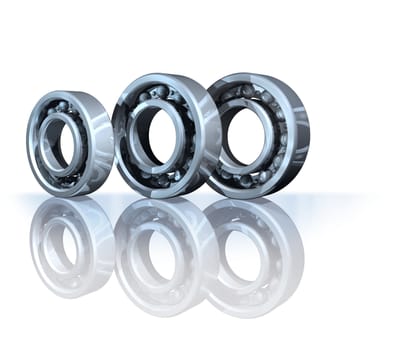 Three metal ball bearings on white reflective background