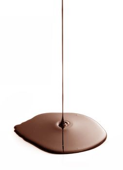 Melted chocolated dripping on white background