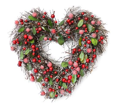 Heart shaped Christmas garland with red berries and green leaves on white background, soft shadows