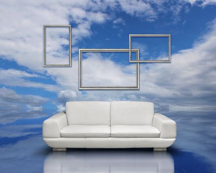 White sofa and silver frames on reflective cloudscape reflection surface