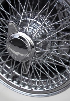 Shiny chromed spoke wheel of a classic sports car