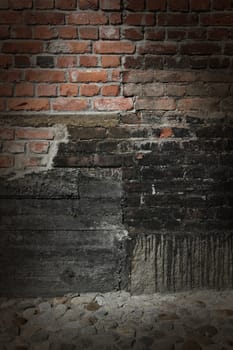 Dark brick and concrete wall with dramatic spot lighting