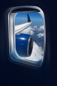 View from a jet plane window high on the blue skies