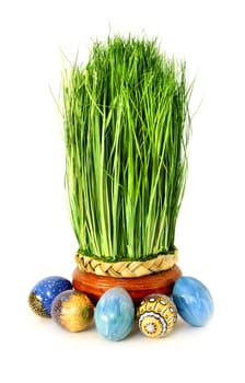 Fresh green easter decoration grass with painted eggs