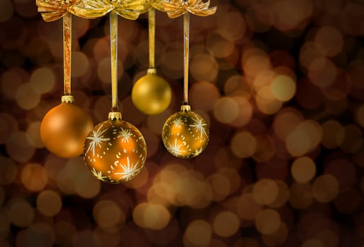 Golden Christmas glass balls on festive light chain color spots sbackground