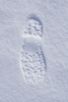 Human boot footprint in newly fallen snow