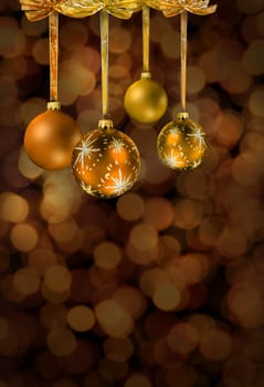 Golden Christmas glass balls on festive light chain color spots sbackground