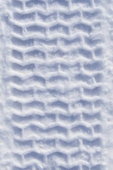 Track of heavy vehicle tire in pure white snow