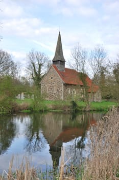 small church reflecting in river