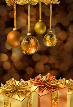 Golden Christmas glass balls and present boxes on festive light chain color spots sbackground