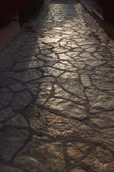 Ancient tiled stone pathway in warm evening backlight