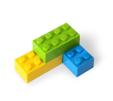 Yellow, green and blue lego blocks assembled together