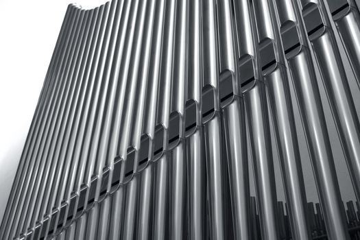 Modern steel organ pipes in a row descending