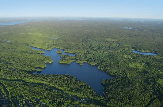 Aerial view of Finnish blue lakes and green forests district 