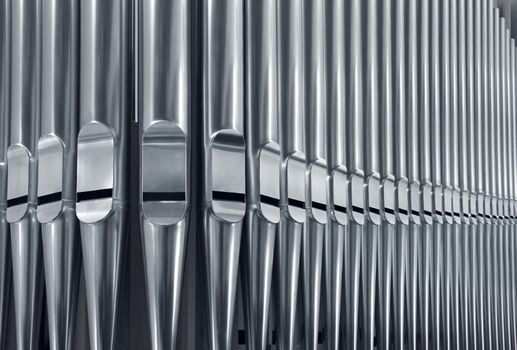 Close-up of modern steel organ pipe set horizontal