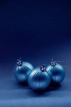 Modern christmas background with glass balls on dark blue background