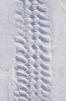  Track of car tire in pure white snow
