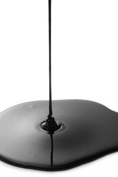 Black oil leaking on growing splatter on white background