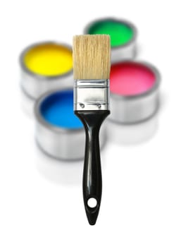 Paint brush with cans of color paint blurred on background