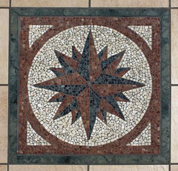 Decorative mosaic compass symbol pattern