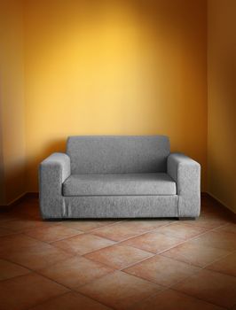 Gray sofa on terracotta tiled floor, in yellow wall room