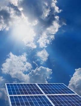 Group of four solar panels on sunny blue sky background