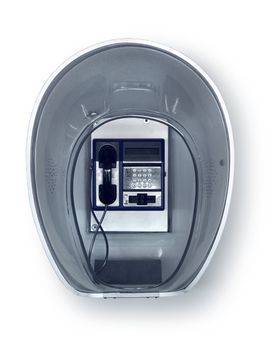 Retro public pay phone in transparent acryl booth