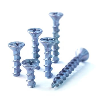 Six steel screws on white background