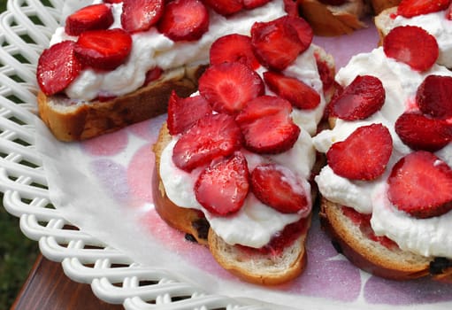 Delicious pastries with fresh strawberries and whipped cream