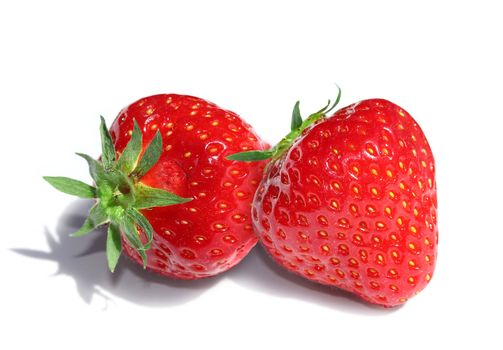 Two delicious red strawberries isolated on white background