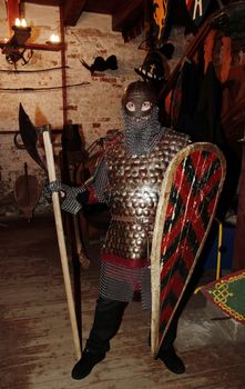 warlike knight in armor against the fortress wall