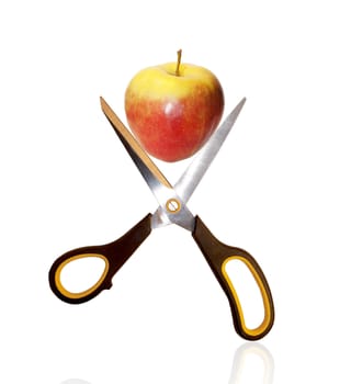 The scissors and red apple over white background