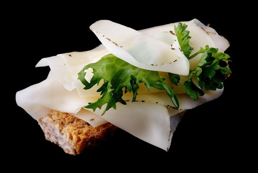 Cheese Sandwich with whole wheat bread and greens isolated on black background