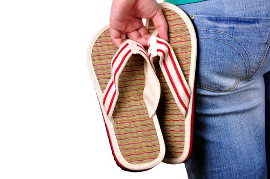 Girl holding sandals on the first day of vacations. Isolated.