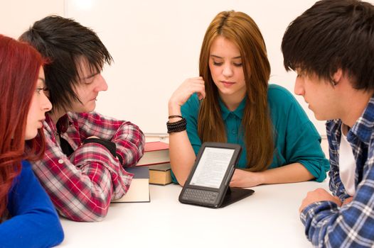 Students around an ebook on their desk