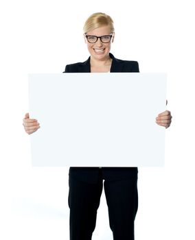 Attractive businesswoman holding blank advertising board wearing glasses