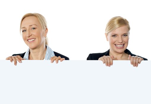 Smiling corporate women showing blank banner ad to camera