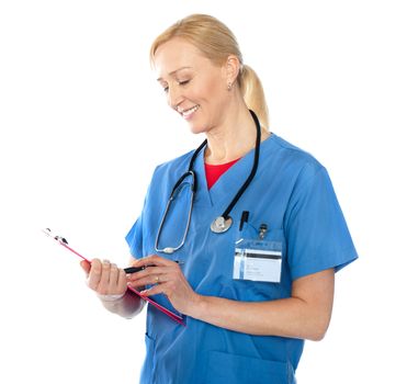 Senior female doctor writing report isolated against white background