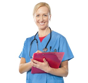 Experienced female doctor holding reports and smiling at camera