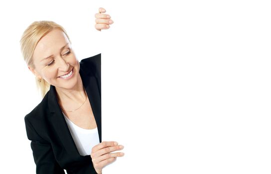 Pretty attractive businesswoman holding blank advertising board