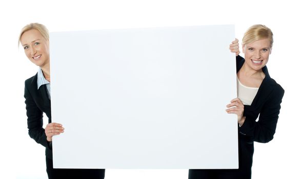 Female business representatives presenting a clipboard isolated over white background