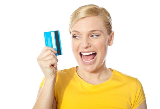 Excited young girl holding debit-card isolated over white background