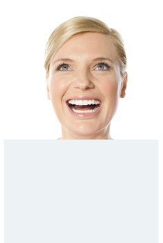 Thoughtful smiling woman holding whiteboard, closeup shot