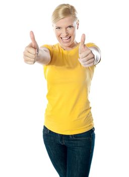 Happy young woman showing double thumbs-up against white background